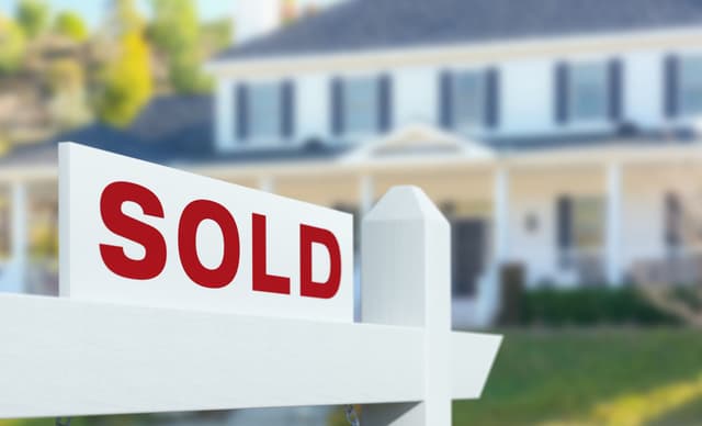 Home with SOLD sign in the front yard